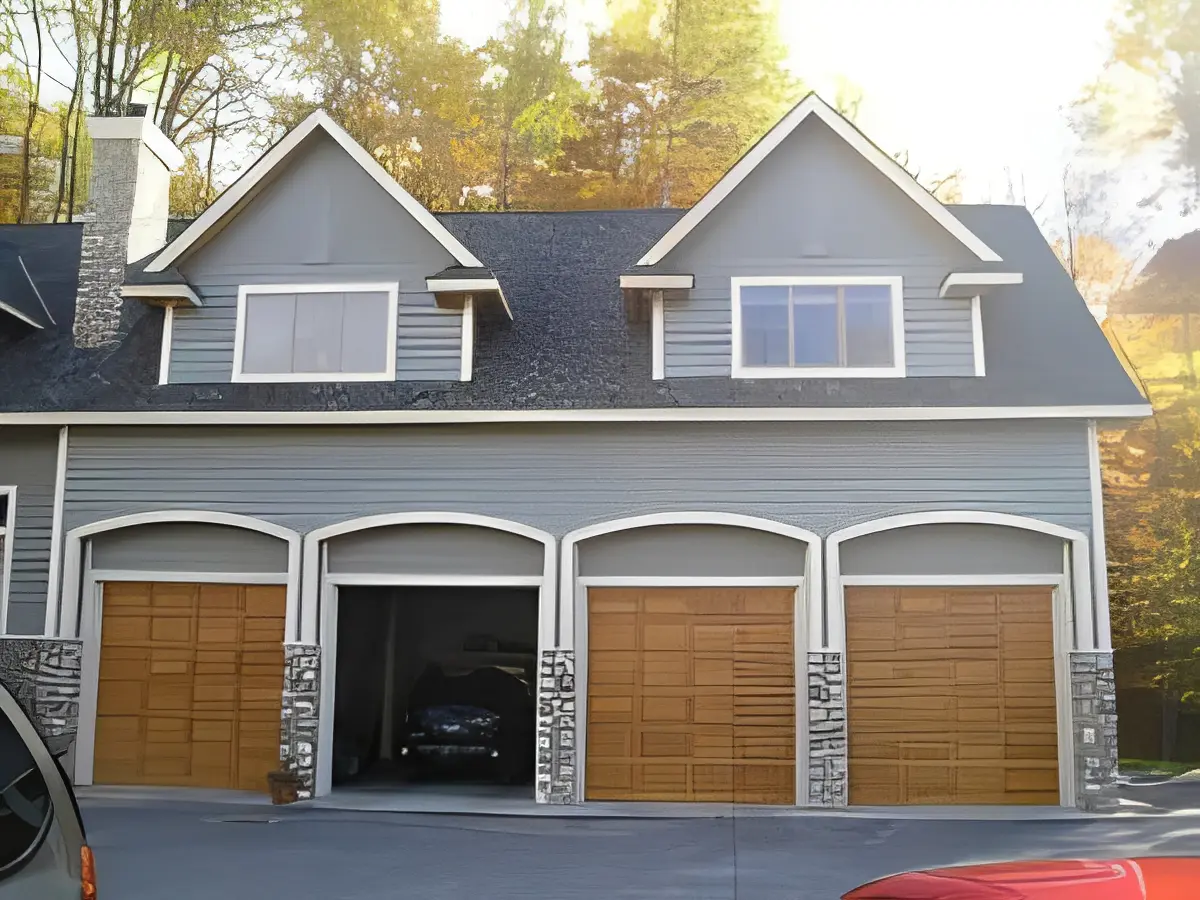 Two-story house with wooden garage doors and stone accents.